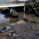 A bulldozer moves debris as a vehicle sits stranded in flooded water on U.S. Highway 101 in Montecito, CA, on January 10, 2018